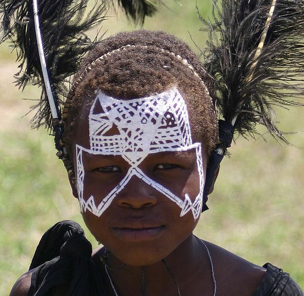 a young child with war-paint on his face