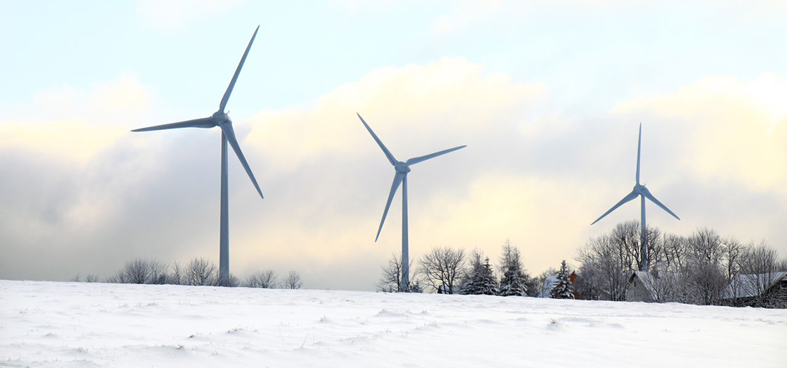 Wind turbine with three blades moored in shallow water.