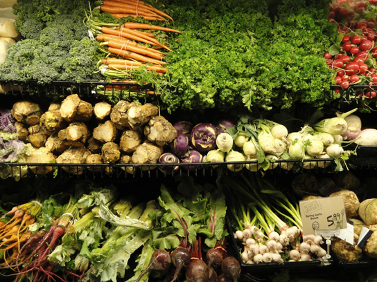  Photos shows a variety of fresh vegetables in a grocery store.