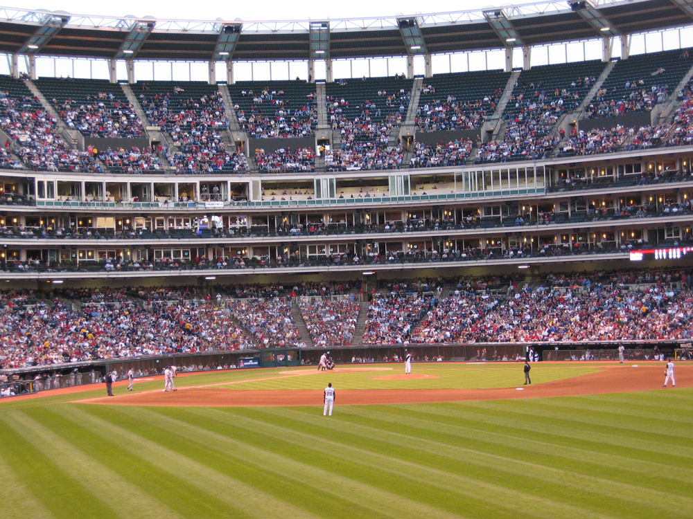 On the left is a photo of an Indian chief. On the right is a baseball stadium.