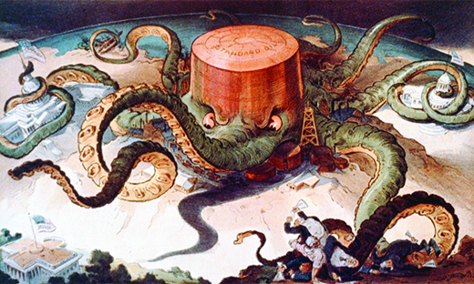 A cartoon shows a massive octopus labeled “Standard Oil.” The octopus’s tentacles wrap around a series of tiny buildings and structures, indicating that it controls the steel, copper, and shipping industries; the U.S. Capitol; and a state house. A final tentacle seeks the White House, but has not yet reached it.