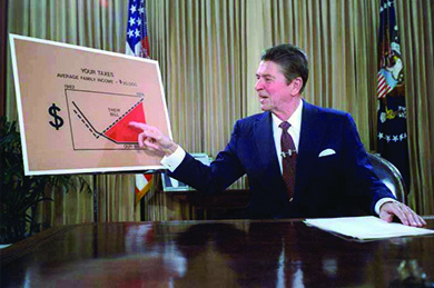 A photograph shows Reagan sitting at a desk, gesturing at a large chart labeled “Your Taxes.”