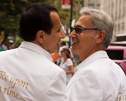 A photo of two recently married men who are smiling.