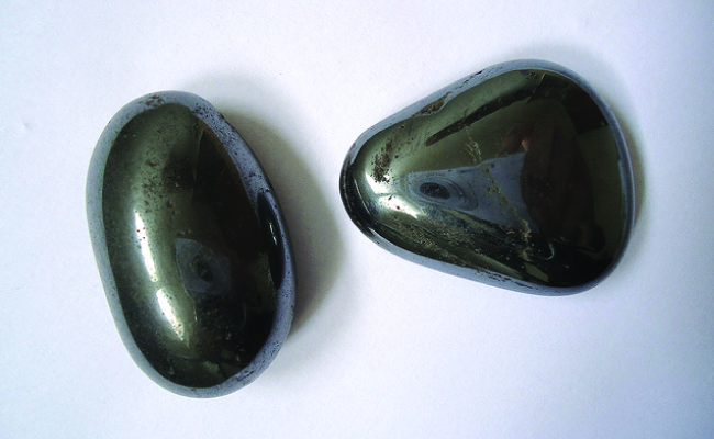 Two rounded, smooth black stones are shown.