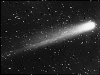 This is a picture of Halley’s Comet. It is a bright ball of light towards the right of the picture with a tail of trailing light. There are also stars throughout the picture.