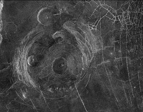 The Fotla Corona. This circular volcanic feature, when seen from above, has the appearance of the beloved Muppets character. Three pancake volcanoes lie within the corona, one below center for the snout, one above and one to the left for the eyes. A single pancake volcano above and outside the corona forms one of the ears.