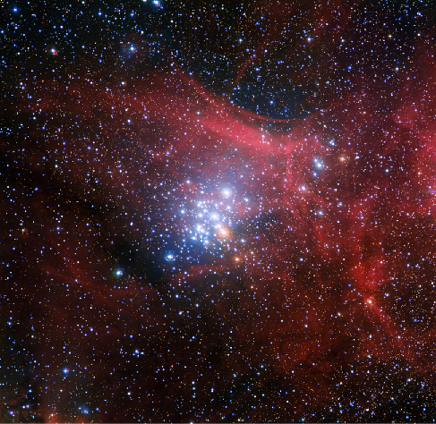 Image of N G C 3293. This compact cluster of bright, blue stars is located near the center of this image surrounded by the red wisps of ionized hydrogen left over after the cluster’s formation.