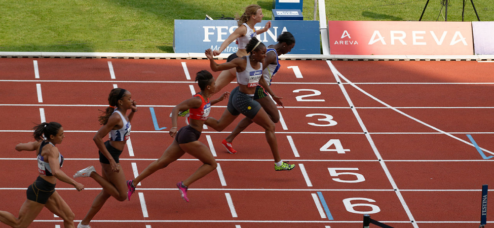 A photo of 6 runners arriving at the finish line of a race.