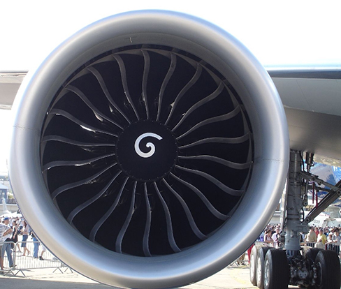 Picture is a photo of an air turbine under the wing of an airplane.