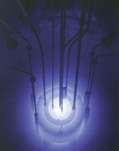 Picture is a photograph of the blue glow in a reactor pool.