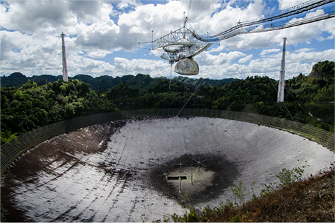 Photograph shows a large parabolic surface.