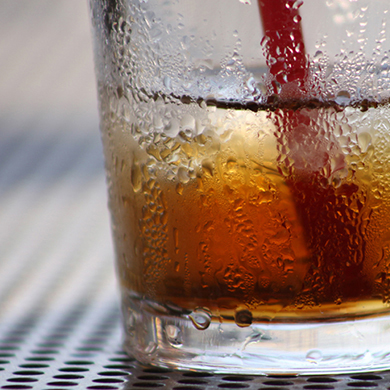 Photograph of condensation on a glass filled with iced tea.