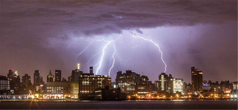 The photo shows lightning strike over several buildings.